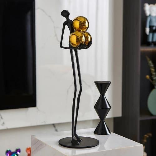 Miniature Human Holding Gold Ball Sculpture