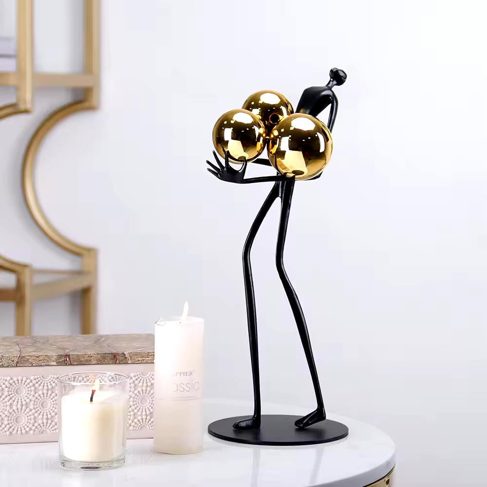 Miniature Human Holding Gold Ball Sculpture