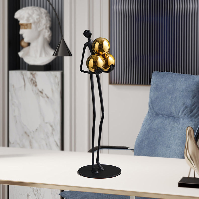 Miniature Human Holding Gold Ball Sculpture