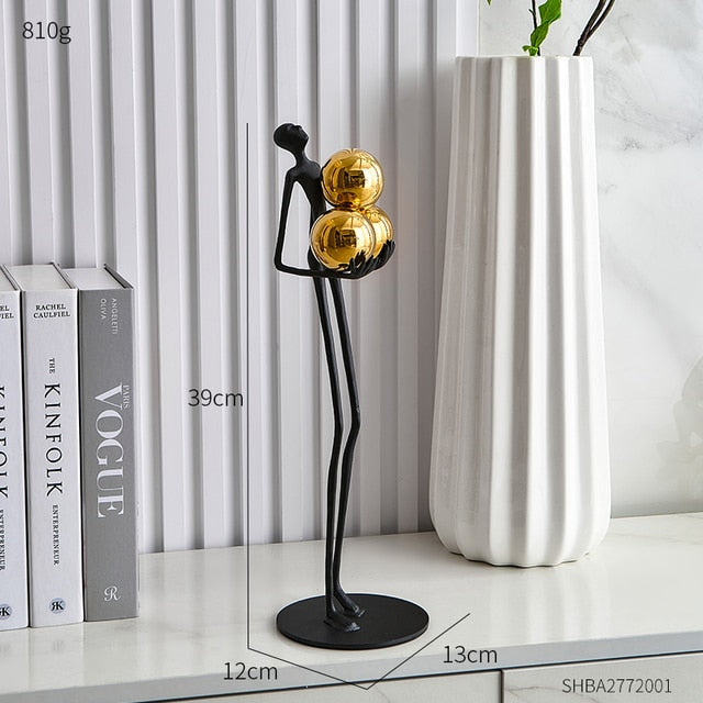 Miniature Human Holding Gold Ball Sculpture
