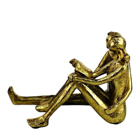 Golden Couple Reading Book Sculpture